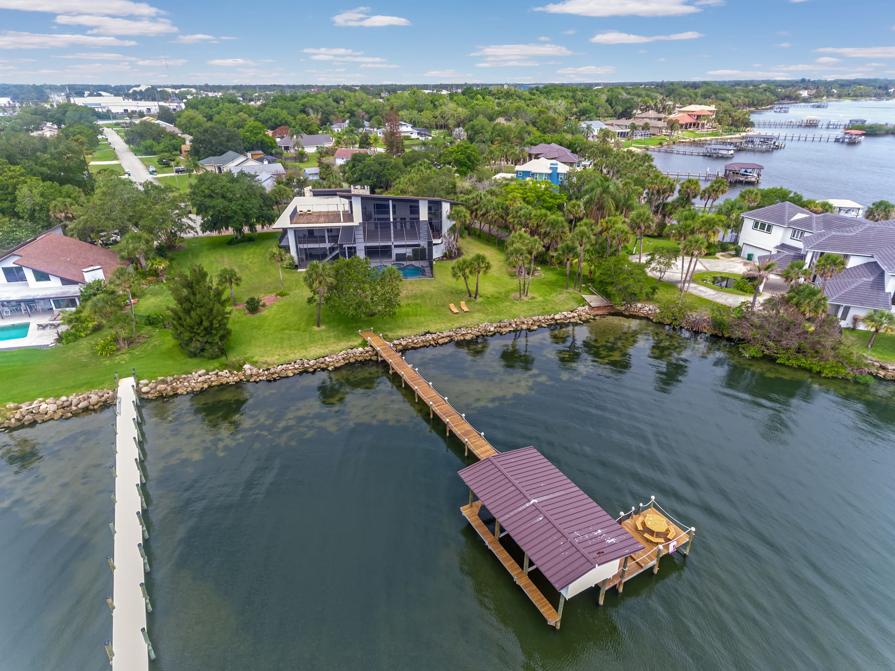 Aerial view of the riverfront property and dock